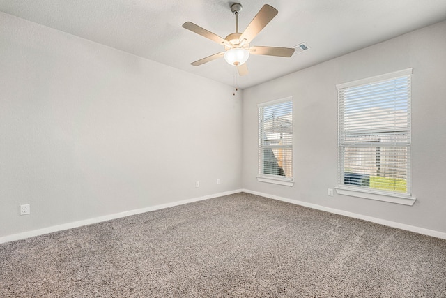 carpeted spare room with ceiling fan