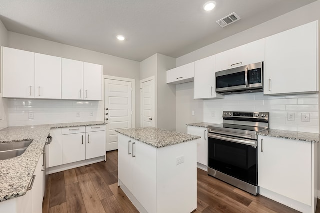 kitchen featuring appliances with stainless steel finishes, a kitchen island, and white cabinetry