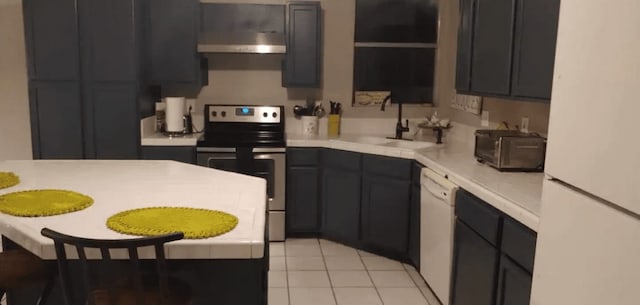 kitchen featuring white refrigerator, extractor fan, sink, light tile patterned floors, and stainless steel electric range