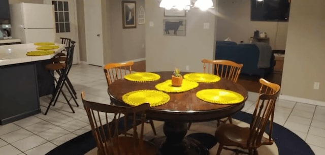 tiled dining area with an inviting chandelier