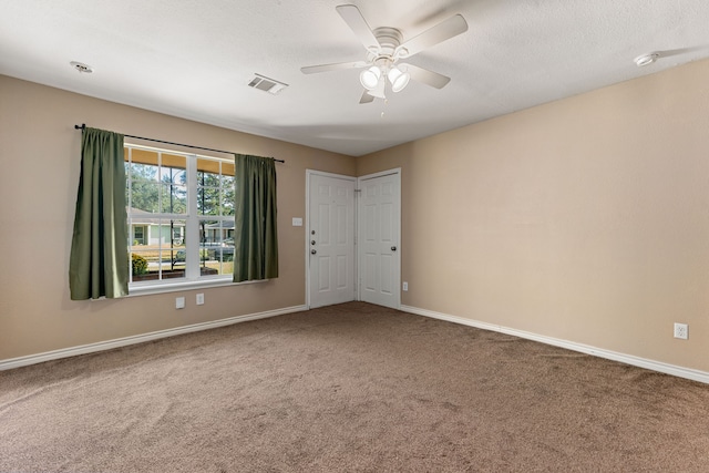 empty room featuring carpet flooring and ceiling fan