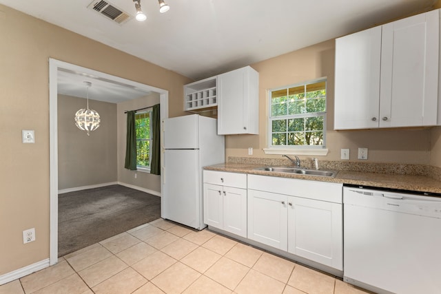 kitchen featuring white cabinetry, sink, pendant lighting, white appliances, and light carpet