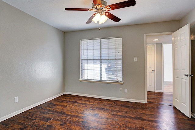 spare room featuring baseboards, ceiling fan, and wood finished floors