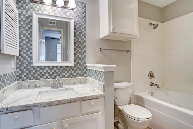 full bathroom featuring shower / bath combination, visible vents, tasteful backsplash, vanity, and toilet