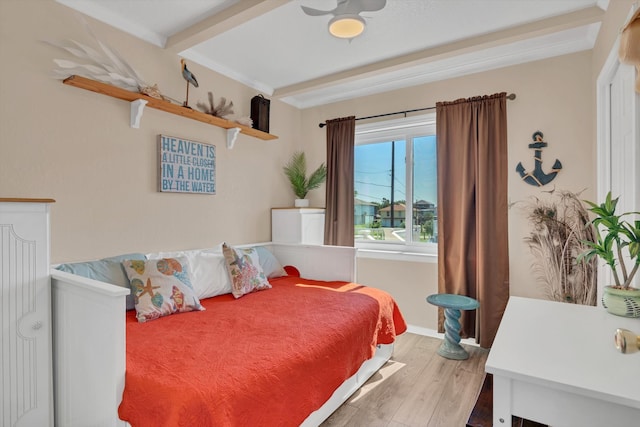 bedroom featuring wood-type flooring and beam ceiling