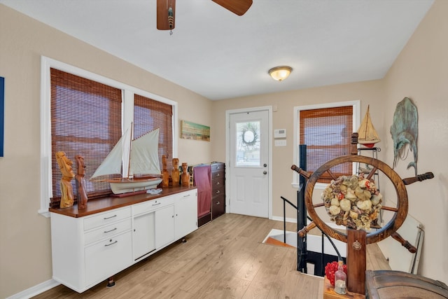 foyer featuring ceiling fan and light hardwood / wood-style flooring