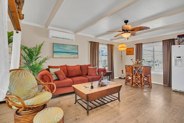 living room with ceiling fan, beamed ceiling, light hardwood / wood-style floors, and a wall mounted air conditioner