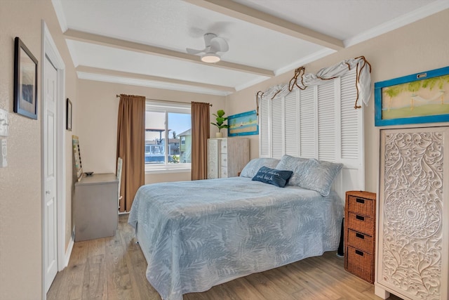 bedroom with ornamental molding, beamed ceiling, ceiling fan, and light hardwood / wood-style flooring