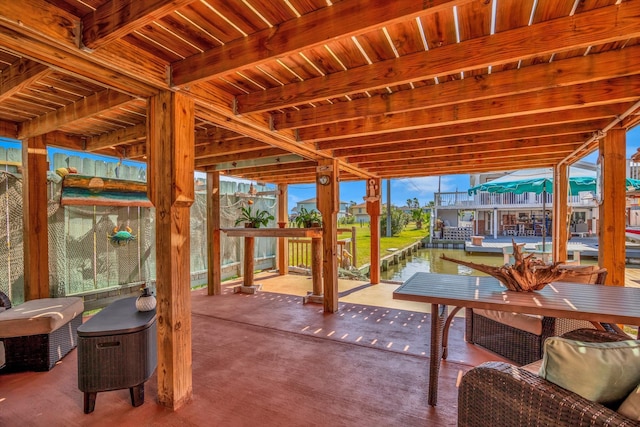 view of patio / terrace featuring a water view and a dock