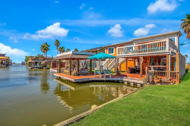 dock area featuring a yard and a deck with water view