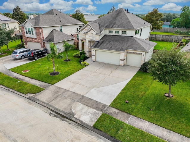 view of front of house featuring a garage and a front lawn