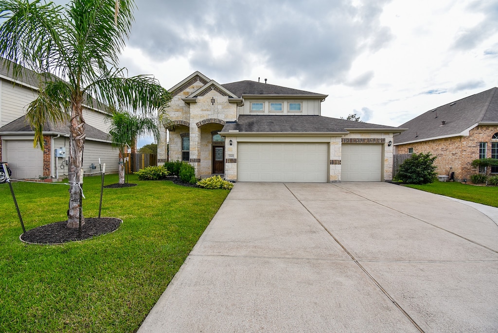 view of front of home with a front yard and a garage