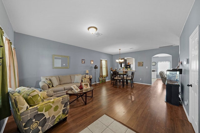 living room with an inviting chandelier and hardwood / wood-style floors