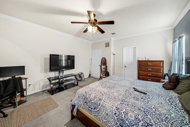 carpeted bedroom with ornamental molding and ceiling fan