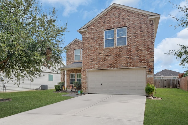 front of property featuring a front yard, a garage, and central AC