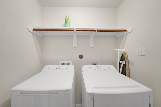 clothes washing area featuring washer and clothes dryer