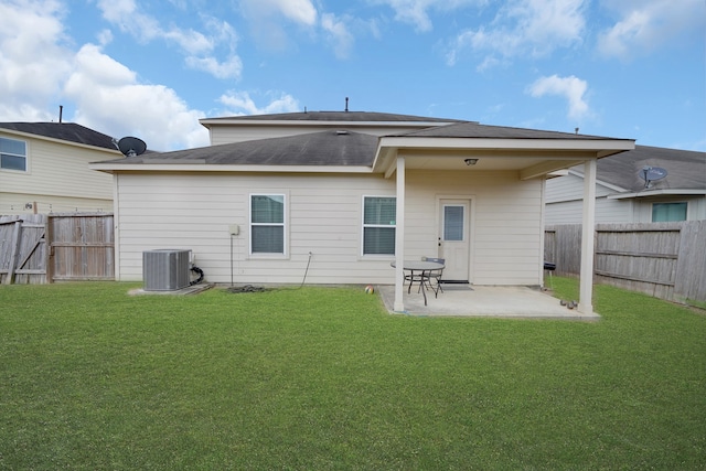 back of property with central air condition unit, a patio, and a lawn