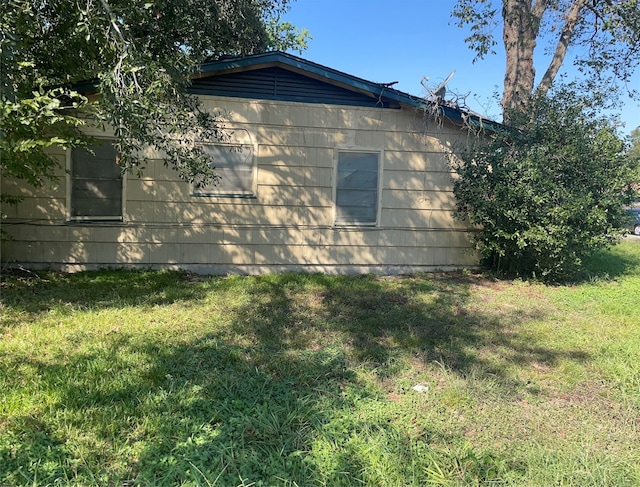 view of side of home featuring a yard