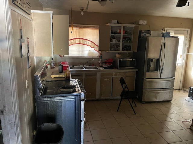 kitchen featuring appliances with stainless steel finishes, decorative backsplash, sink, and light tile patterned floors