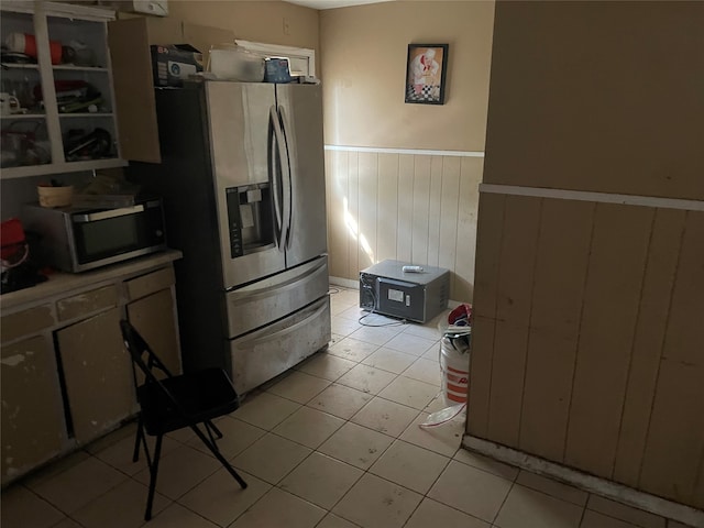 kitchen with wood walls and stainless steel appliances