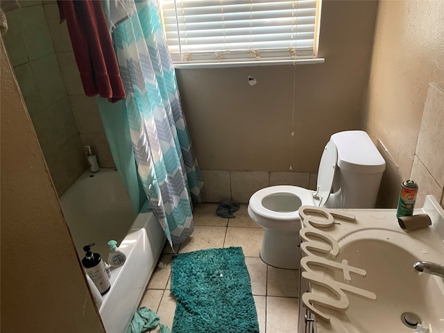 bathroom with toilet, shower / bath combo with shower curtain, and tile patterned flooring