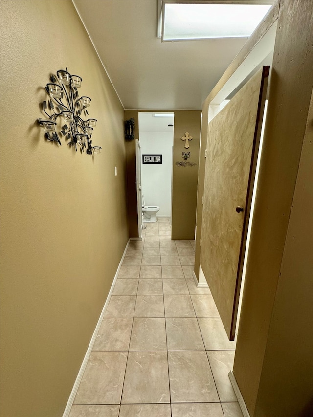 hall with light tile patterned flooring