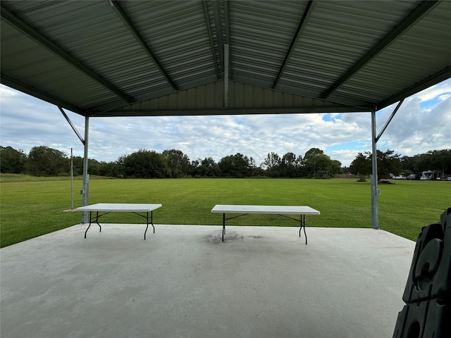 view of property's community with a yard and a patio