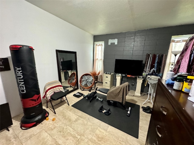 exercise room with a textured ceiling