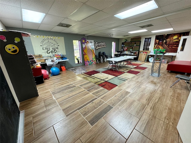 game room featuring a paneled ceiling