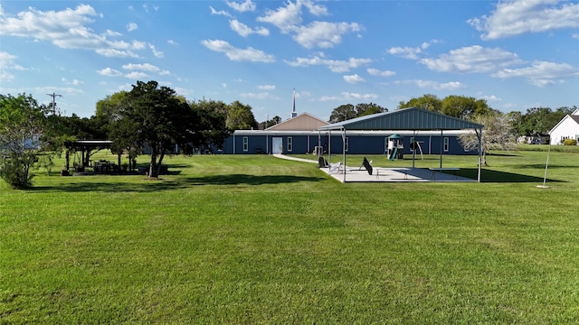 view of property's community featuring a lawn and a patio