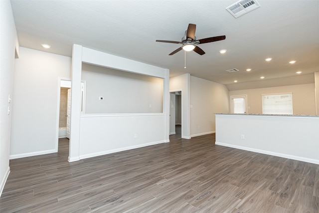 unfurnished living room featuring ceiling fan and dark hardwood / wood-style flooring