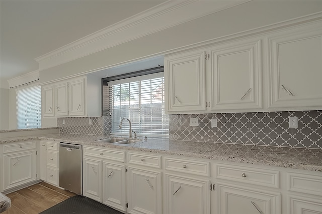 kitchen featuring light hardwood / wood-style floors, sink, ornamental molding, white cabinets, and stainless steel dishwasher