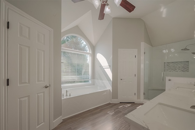 bathroom featuring ceiling fan, separate shower and tub, hardwood / wood-style flooring, and vaulted ceiling