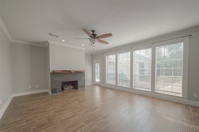 unfurnished living room featuring ceiling fan, a brick fireplace, plenty of natural light, and hardwood / wood-style floors