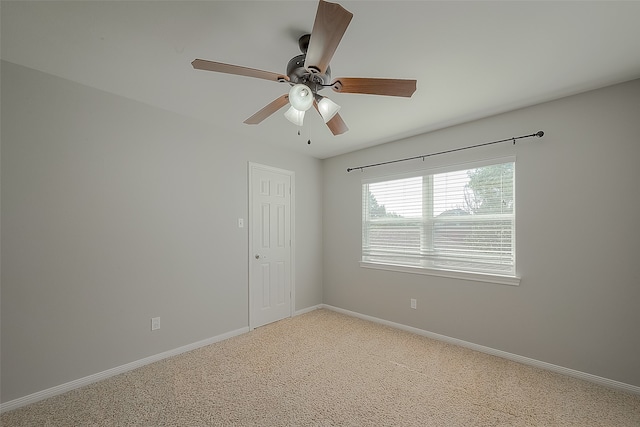 carpeted spare room with ceiling fan