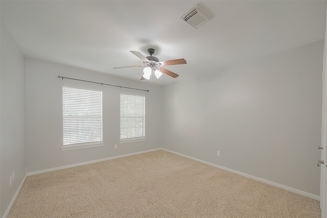 spare room with carpet and ceiling fan