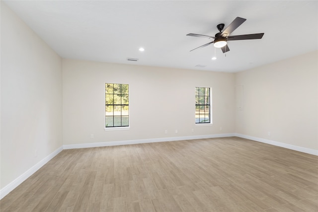 empty room with light wood-type flooring and ceiling fan