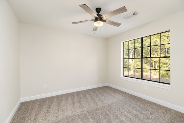 carpeted empty room with ceiling fan and a healthy amount of sunlight