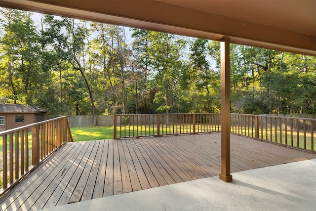 wooden deck featuring a lawn