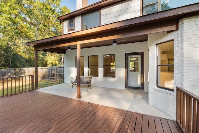 wooden terrace featuring a patio and ceiling fan