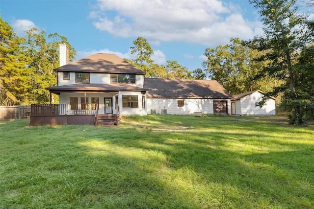9 Timber Wood Ln, Conroe, TX 77384 - back of property featuring a chimney and a deck