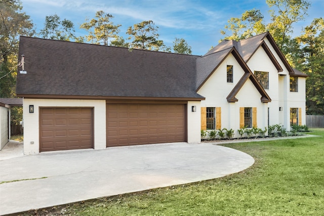 view of front of house featuring a front yard and a garage