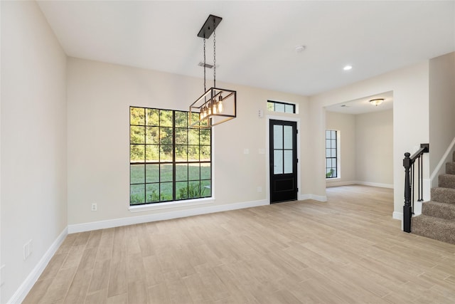 9 Timber Wood Ln, Conroe, TX 77384 - spare room featuring stairs, light wood-style flooring, baseboards, healthy amount of natural light, and recessed lighting