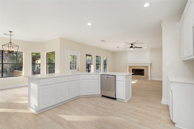 kitchen featuring dishwasher, a center island, decorative light fixtures, light wood-type flooring, and white cabinets