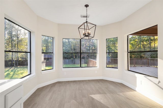 unfurnished sunroom with a notable chandelier and plenty of natural light