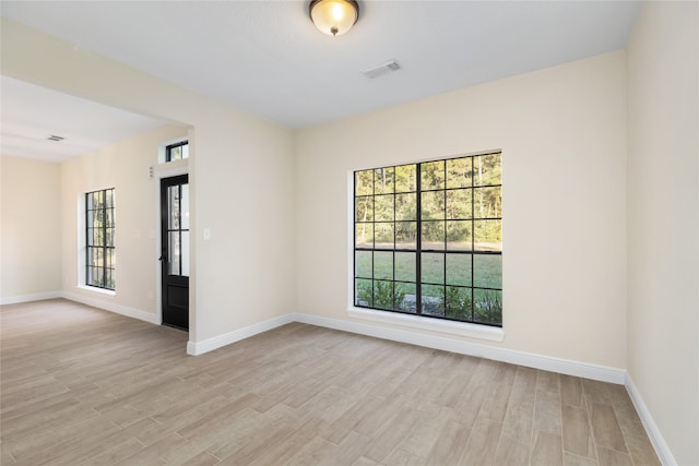 unfurnished room with light hardwood / wood-style floors