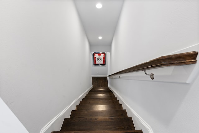 staircase with hardwood / wood-style flooring