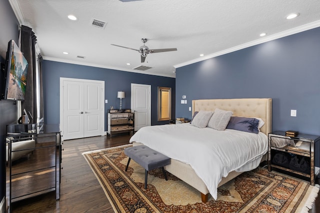 bedroom with ceiling fan, ornamental molding, a textured ceiling, and dark wood-type flooring