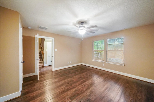 unfurnished room featuring dark wood-type flooring and ceiling fan