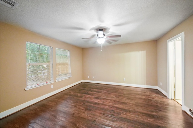 unfurnished room with ceiling fan, dark hardwood / wood-style floors, and a textured ceiling